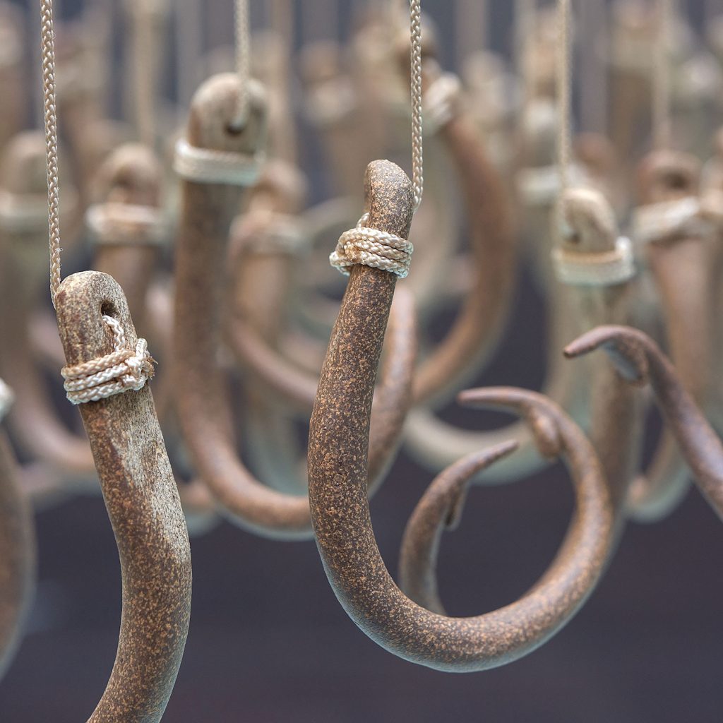 Detail of Long Lines, 132 suspended Ceramic hooks by Annette Bellamy