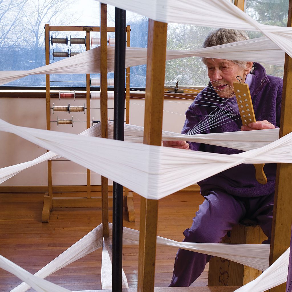 Ethel Stein preparing a warp for her 2008 browngrotta exhibition and Monograph “Ethel Stein: Weaver”. Photo by Tom Grotta