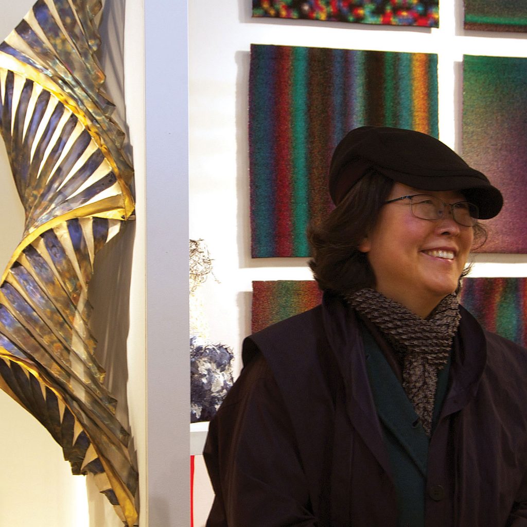 Jin-Sook So  in front of one of her Untitled Steel Mesh wall sculptures at SOFA NY 2011. Photo by Carter Grotta