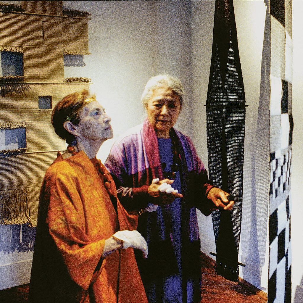 Lenore Tawney at her retrospective exhibition: Lenore Tawney: celebrating five decades of work touring the opening with her best friend Toshiko Takeazu in 2000. Photo by Tom Grotta