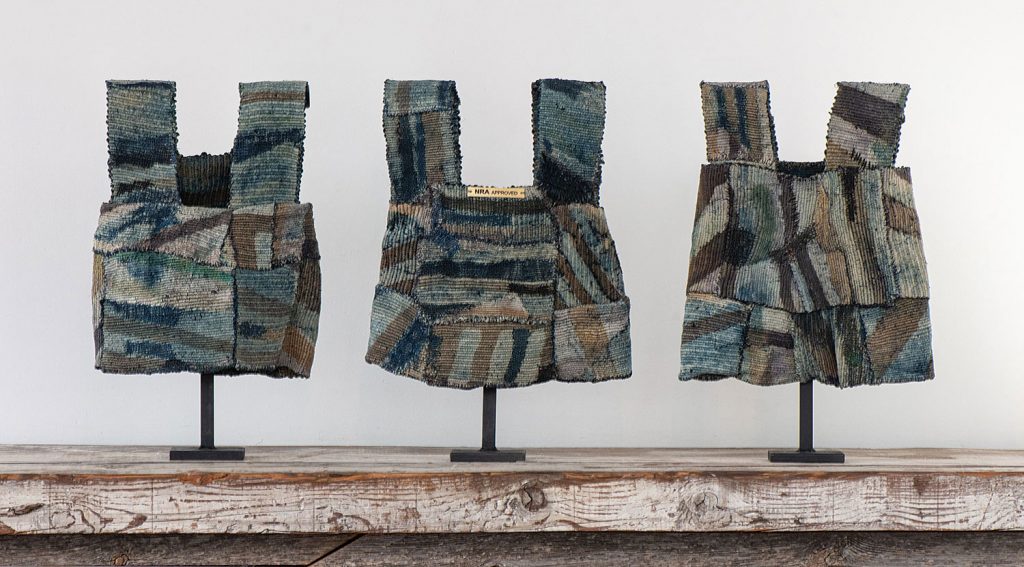 NRA Approved,  James Bassler, woven, stitched and batik dyed; silk and sisal; each 20”h X 12”w X 4”d (as mounted), 3 pieces in one box  with 3 custom stands, 2014.Photo by Tom Grotta