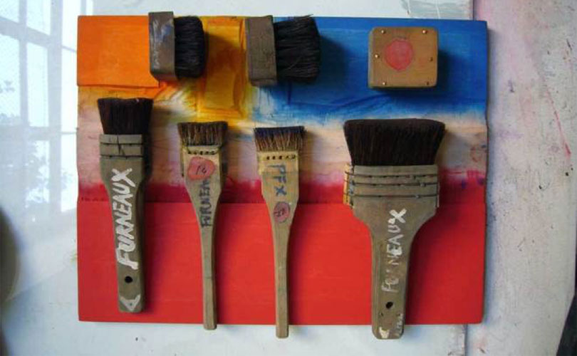 Brushes on an inked piece of woodblock